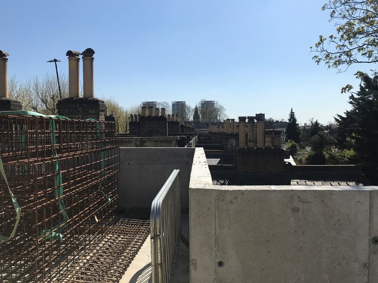 On the residents’ roof terrace at Almshouse, Bermondsey looking south to St. Anne’s church and the towers of the Avondale Square estate.