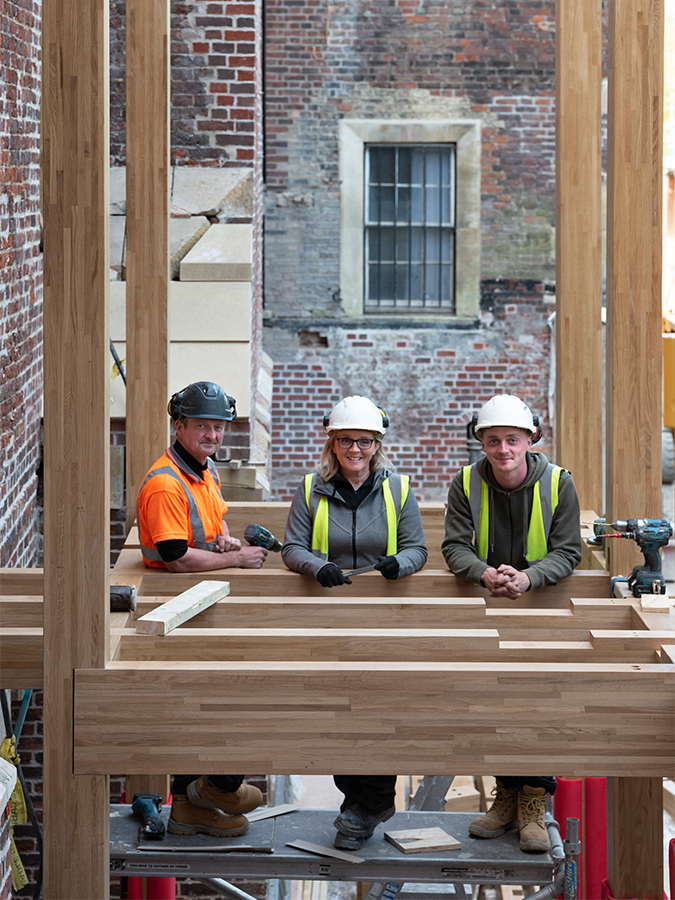 The laminated oak frame at Clare College, Cambridge being assembled on site by Engineered Timber Buildings Ltd. – a family firm from Huddersfield, run by Sarah and Darren Kynaston, with son Will.