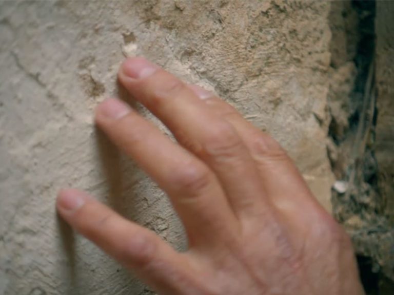 Kevin McCloud stroking the stone at Astley Castle