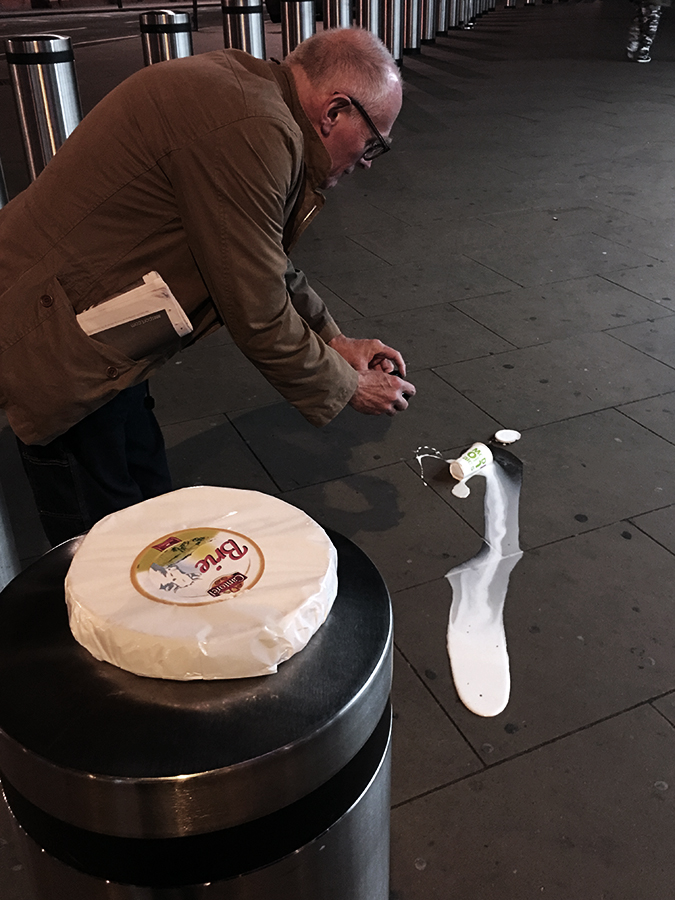 Richard Wentworth taking photo of fallen McDonalds milkshake with brie on bin
